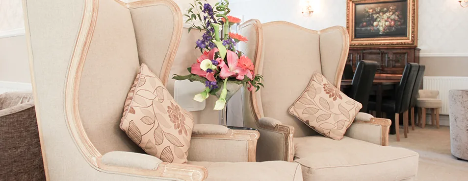 Wing-back chairs and flowers in the lounge