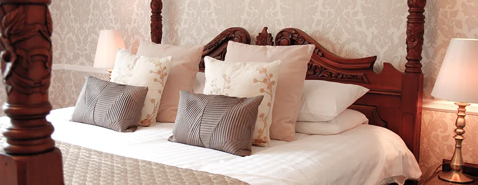 A four-poster bedroom at Llechwen Hall
