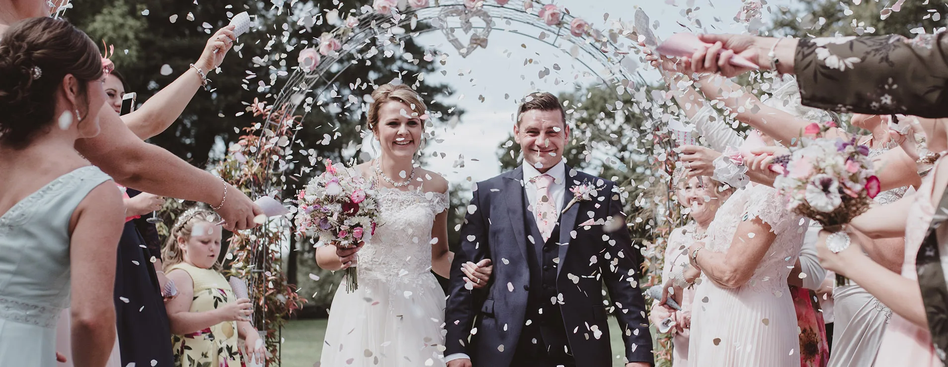 Confetti thrown over a couple leaving the ceremony